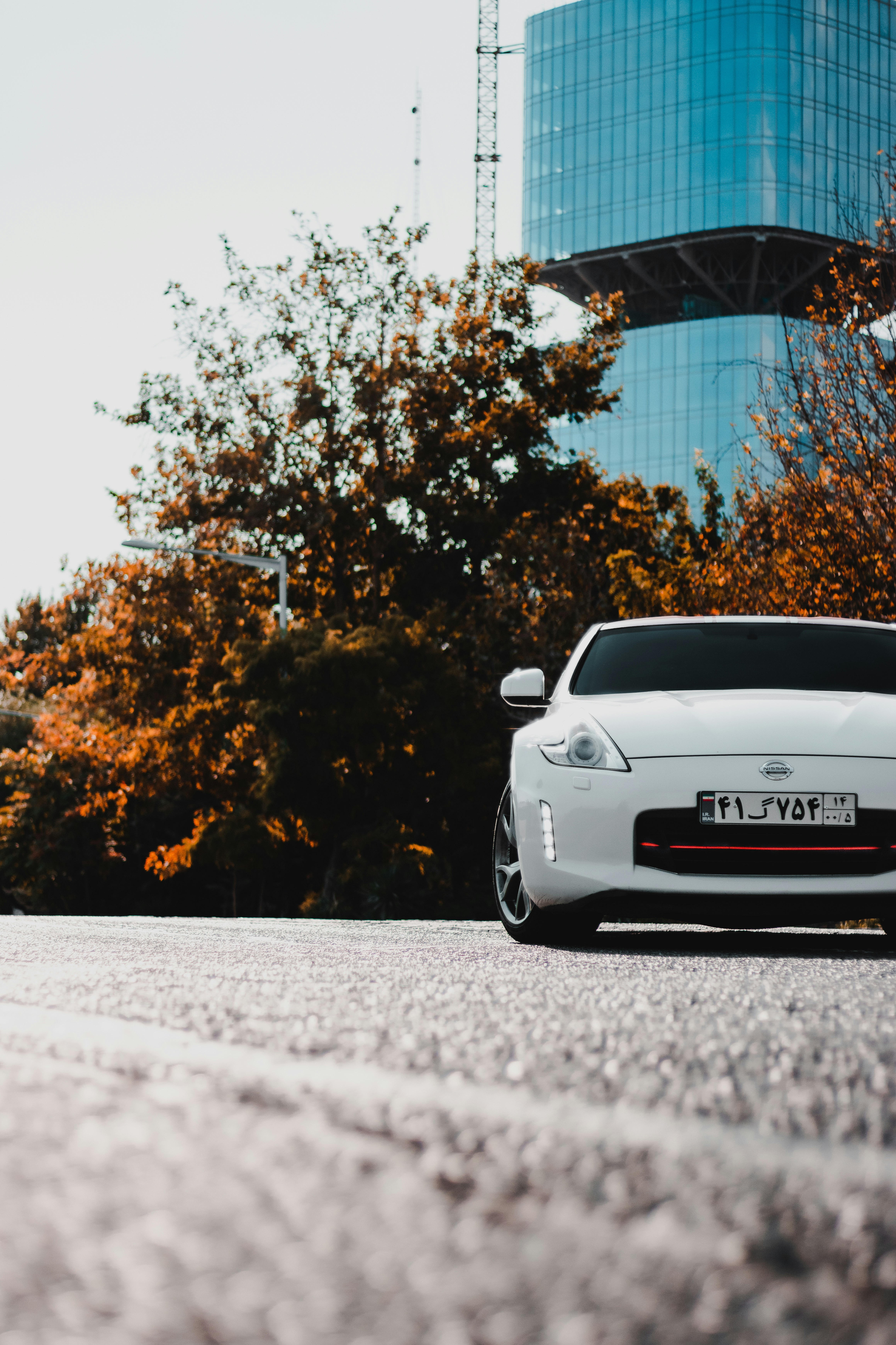 white porsche 911 parked near trees during daytime